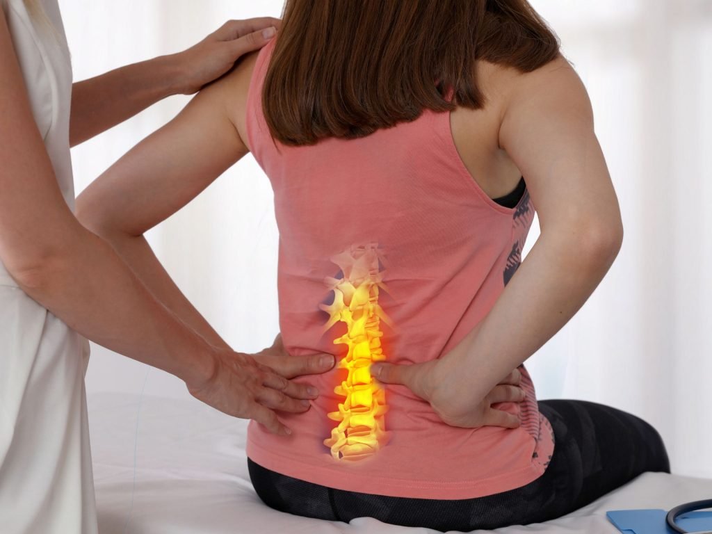 alt="Chiropractor carefully assessing a patient's spine at our Gourock clinic to identify the root cause of their chronic back pain."