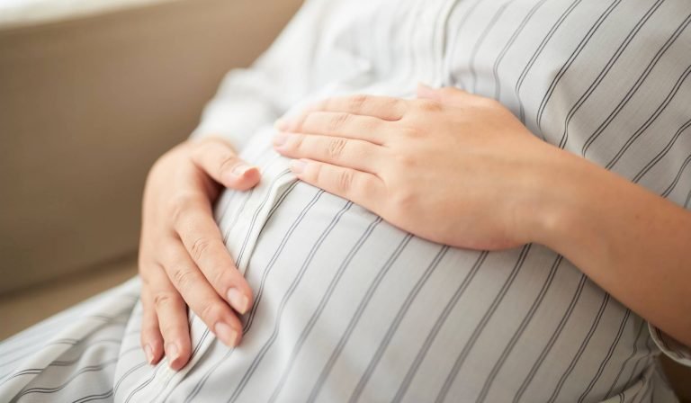 alt="A relaxed pregnant woman enjoying a comfortable and active pregnancy through gentle prenatal care."