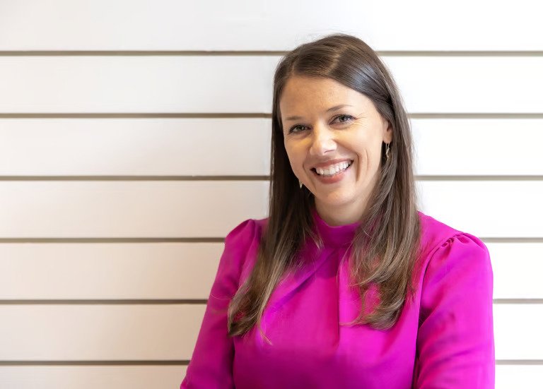 alt="Fiona, Lead Chiropractor at Inverclyde Chiropractic, smiling in her professional clinic setting in Gourock."